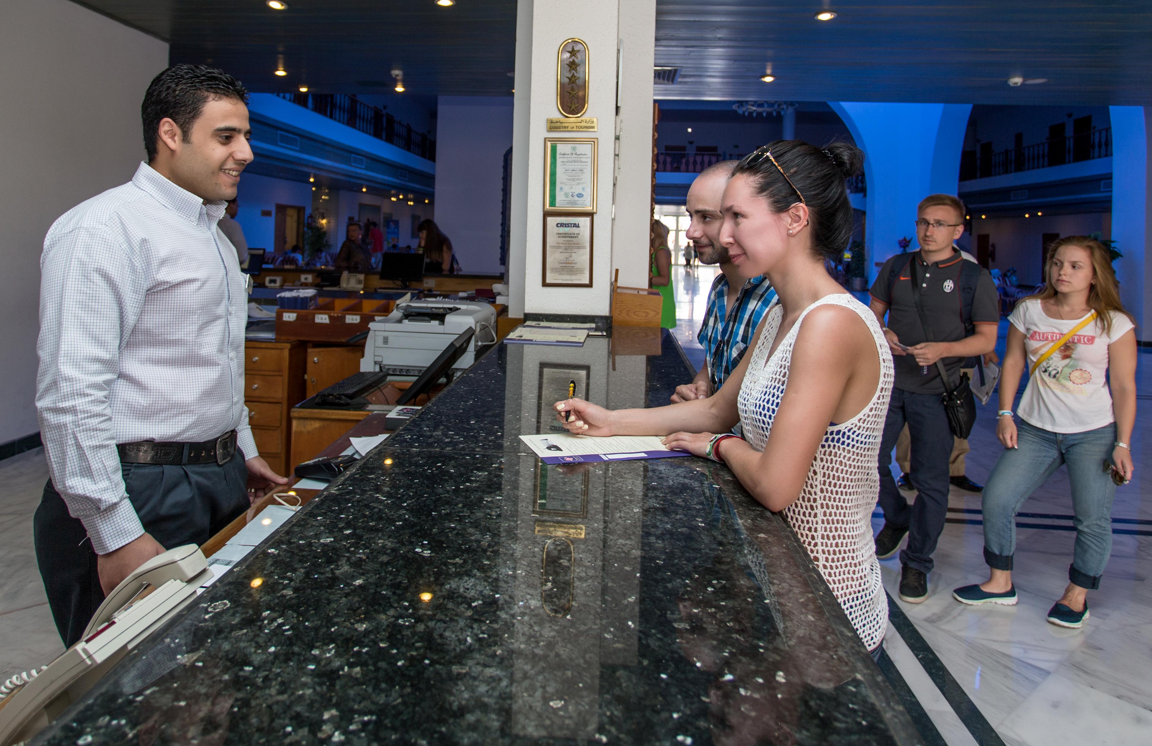 Desert Rose Resort Hurghada Esterno foto A guest checking in at the front desk of a hotel