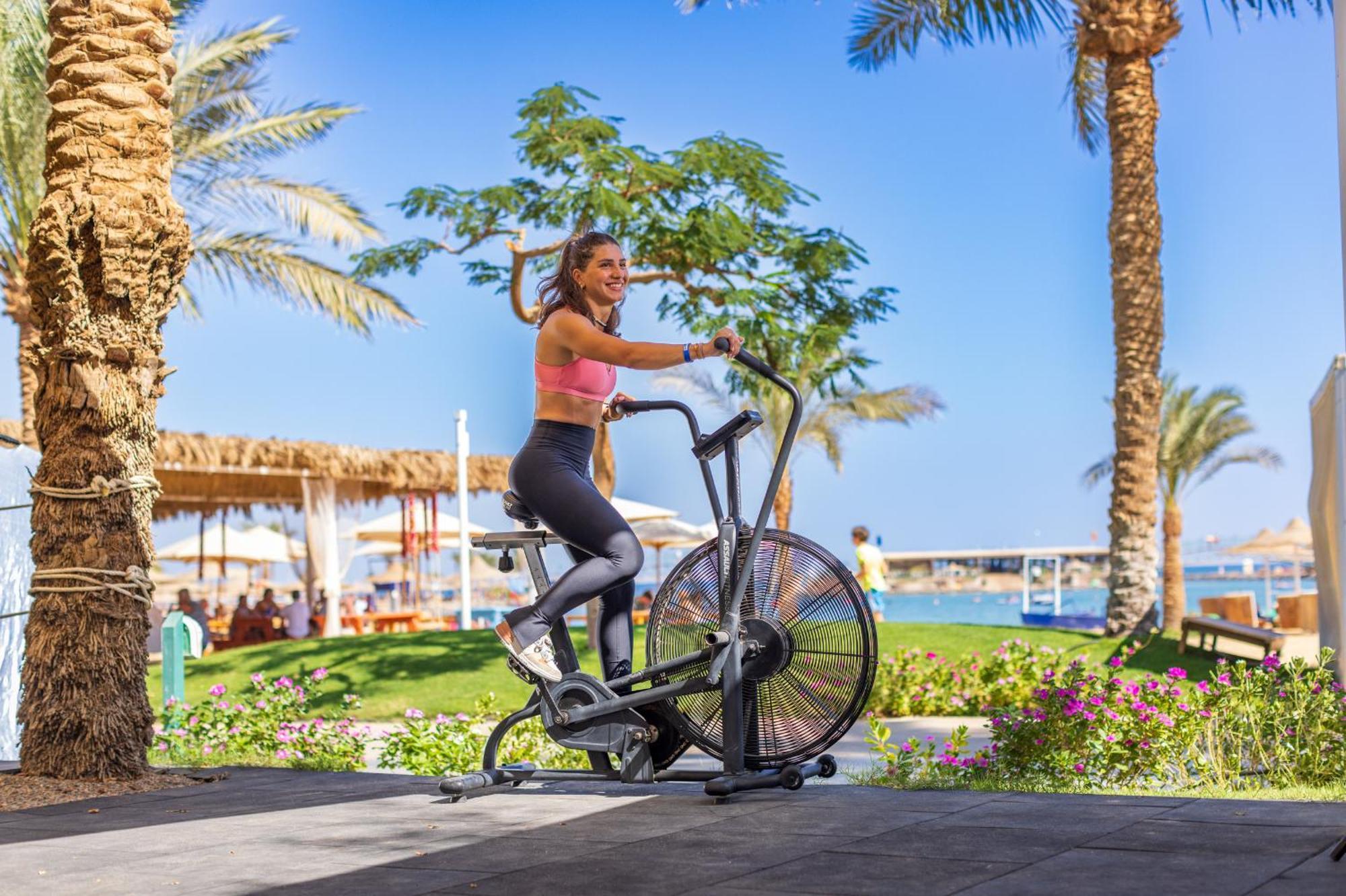 Desert Rose Resort Hurghada Esterno foto A woman on an air bike